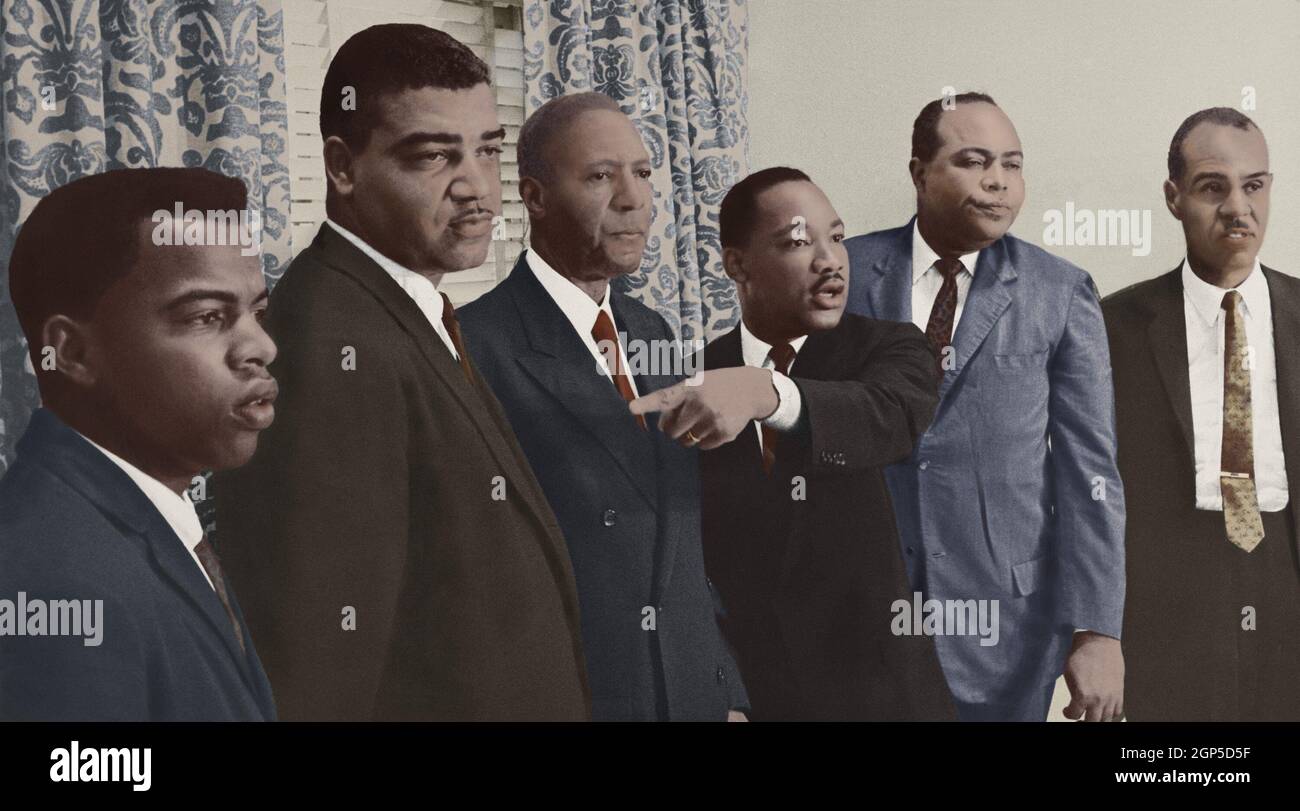 The 'Big Six' African American leaders of civil rights organizations met to plan their participation in the 1963 March on Washington. Martin Luther King Jr. points to John Lewis (far left), while meeting with the press at the Hotel Roosevelt, New York City, July 1, 1963. Lewis, 24, was the Chairman of the Student Nonviolent Coordinating Committee (SNCC), a veteran of the Nashville Sit-Ins of 1960, and the Freedom Rides of 1961. L-R: John Lewis, SNCC; Whitney Young, National Urban League; A. Philip Randolph, Brotherhood of Sleeping Car Porters; Rev. Martin Luther King, Jr., SCLC; James Farmer, Stock Photo