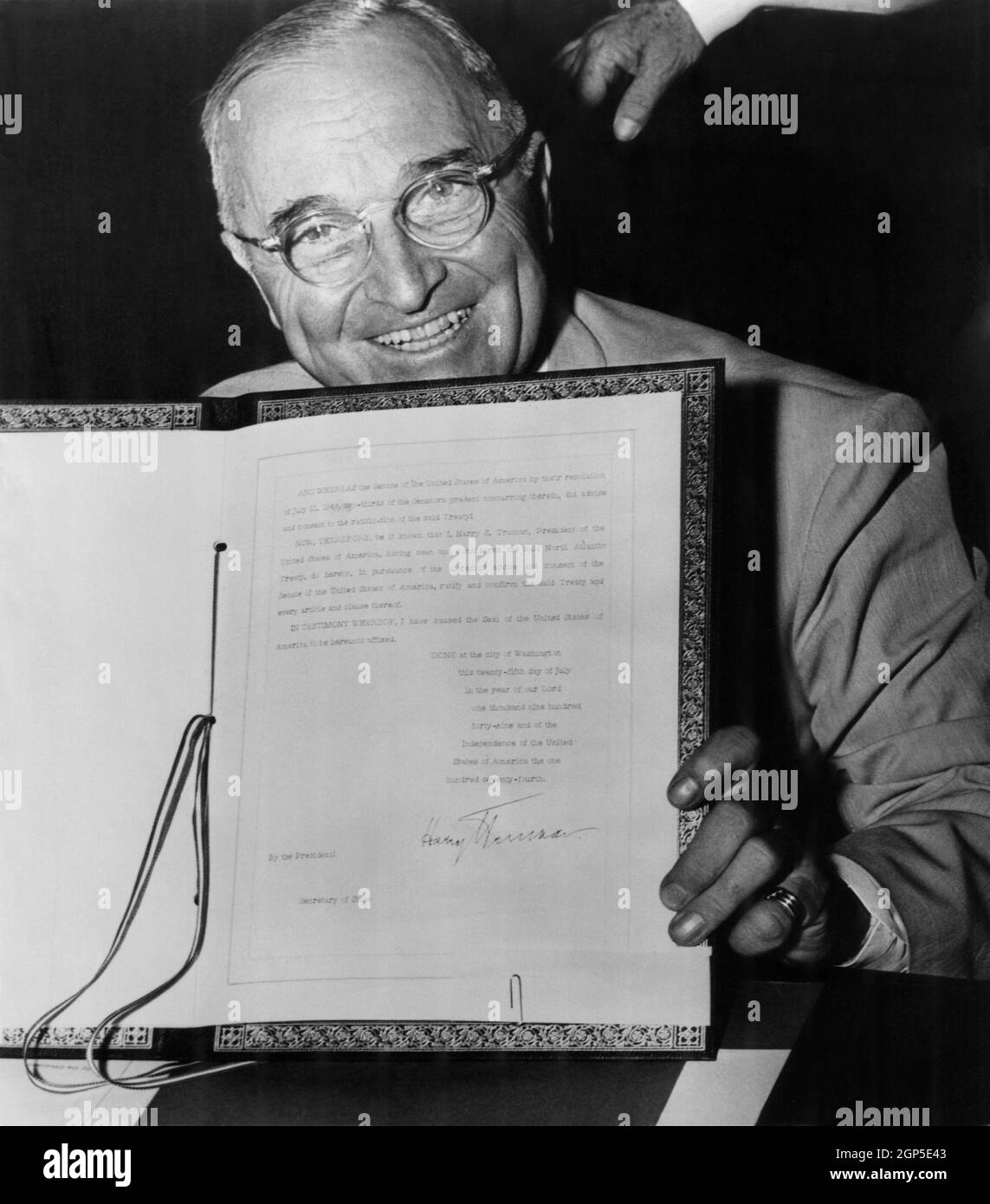 President Truman displays his signature on the ratification of the ...