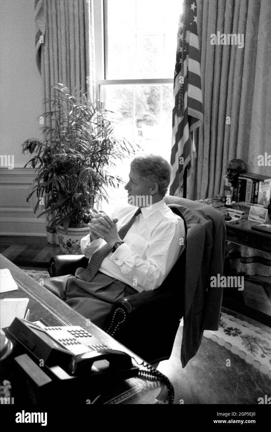 President Bill Clinton in shirtsleeves at his Oval Office desk on