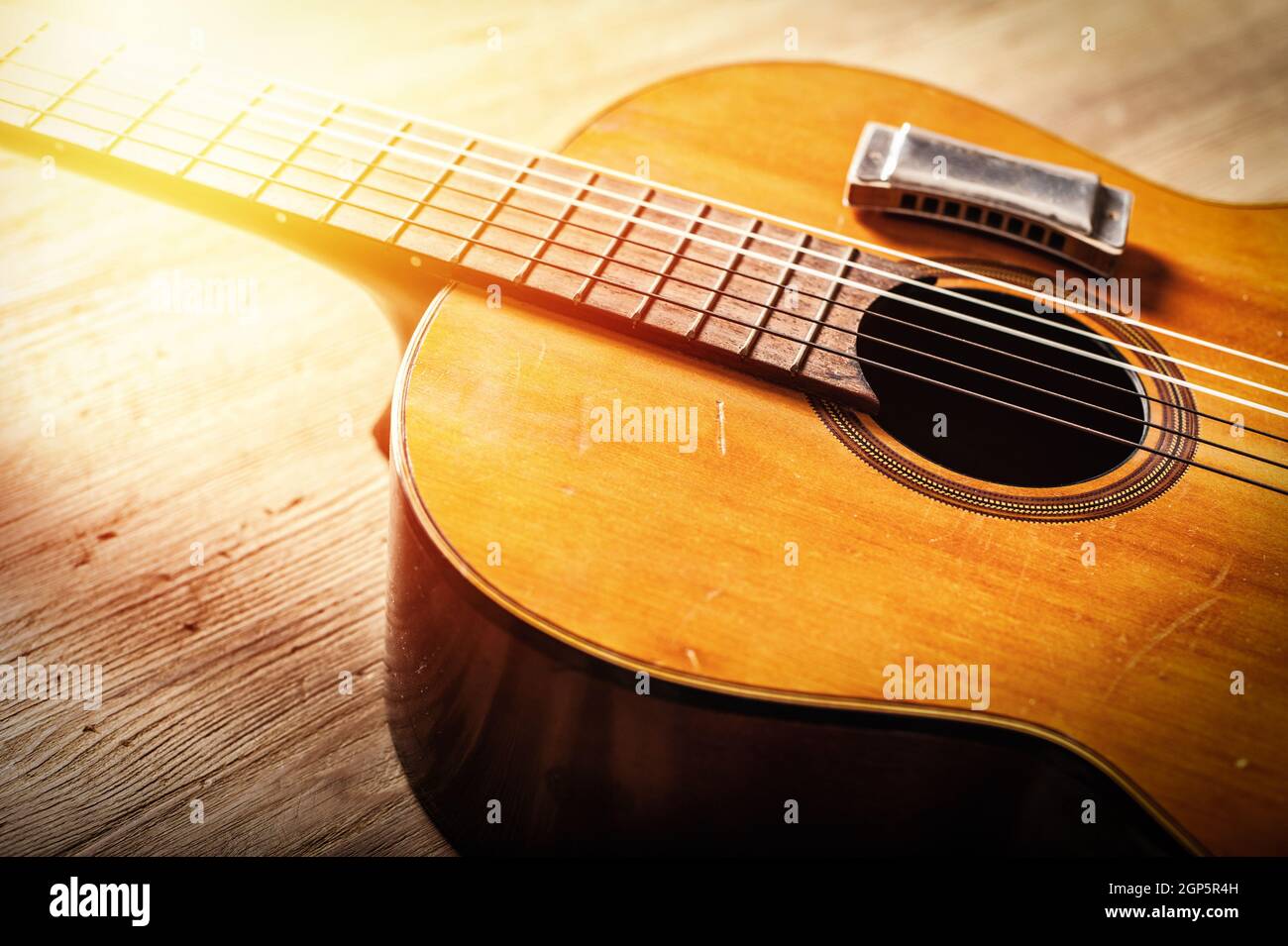 closeup classical guitar with harmonica over wood background Stock Photo