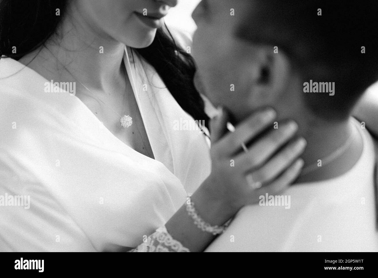 the bride and groom tenderly hold hands between them love and relationships Stock Photo