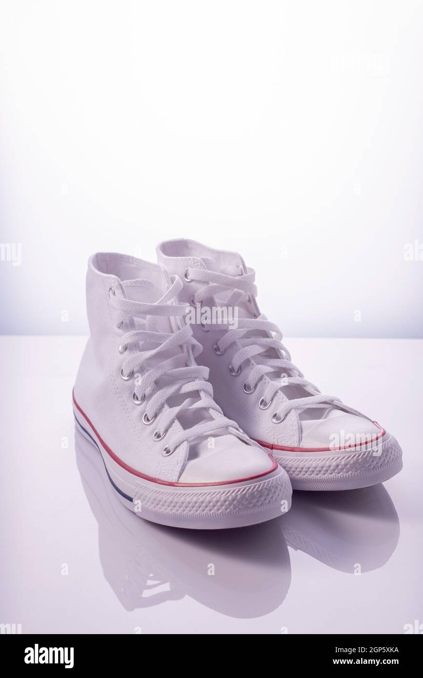 white sneakers with a red stripe on a 