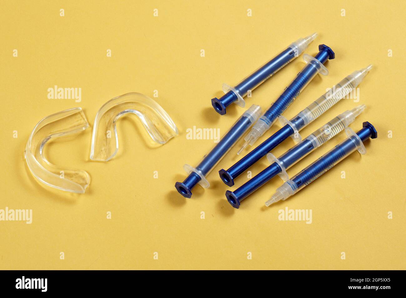 Home teeth whitening kit with peroxide gel syringes and rubber mouth