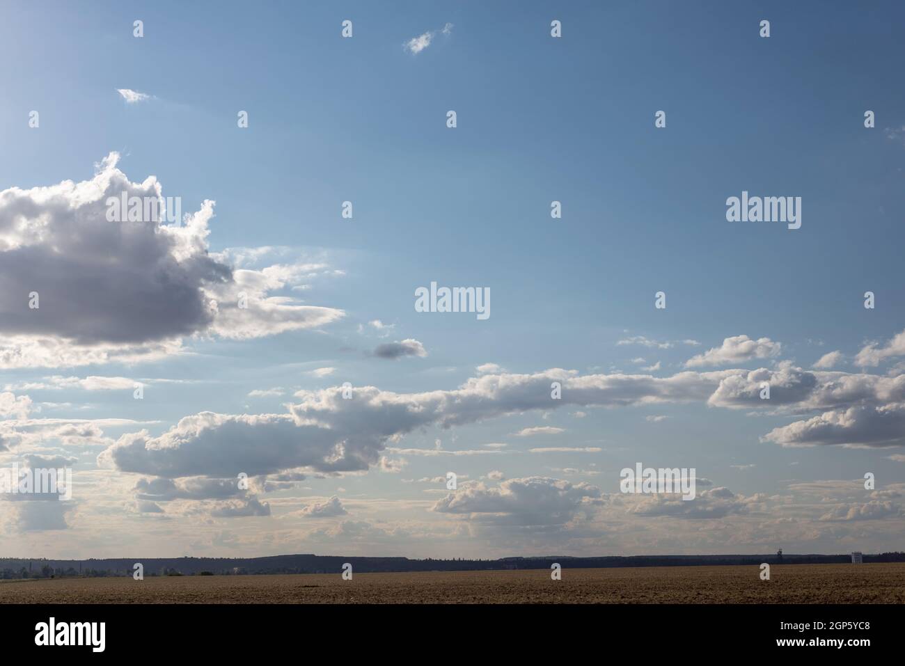 cloudy sky landscape fields with nature trees. Stock Photo