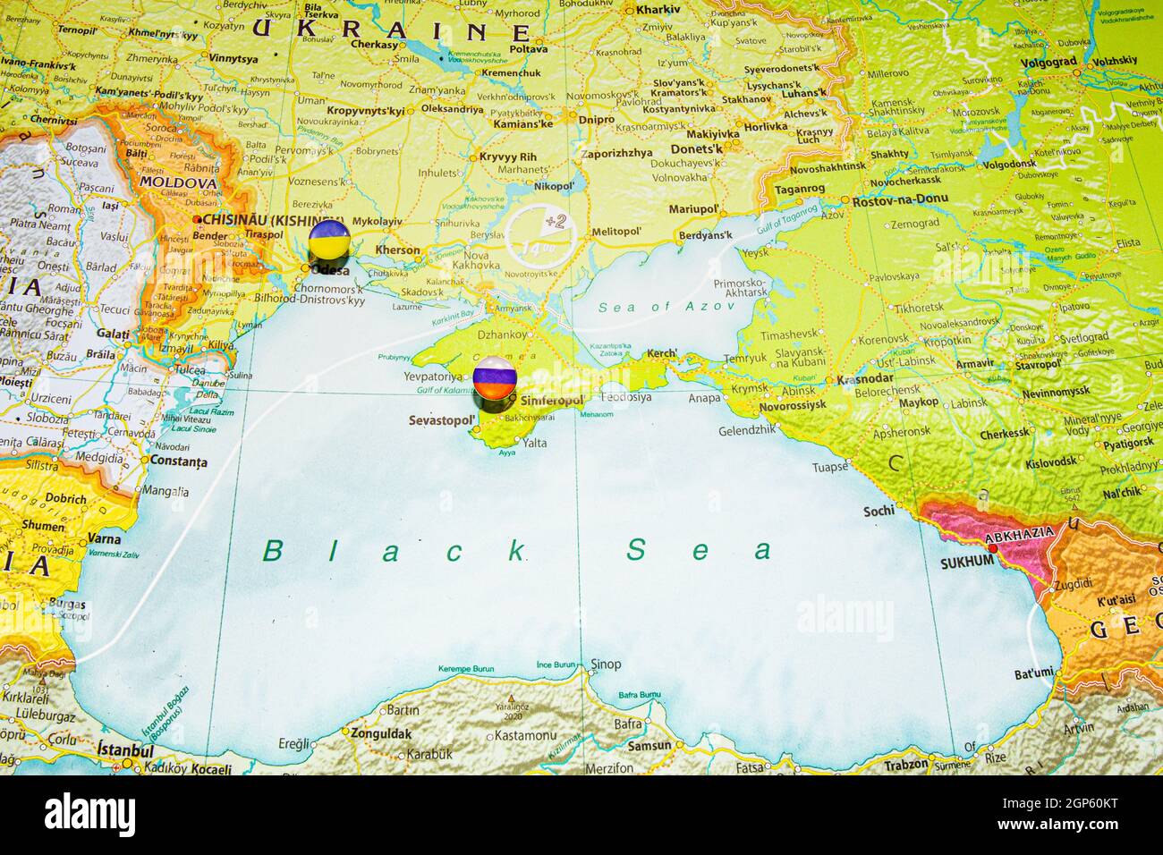 Close up view to Crimea with Russian flag pin. New land and sea borders of Ukraine and Russia territory on political map of Europe, geographical globe Stock Photo