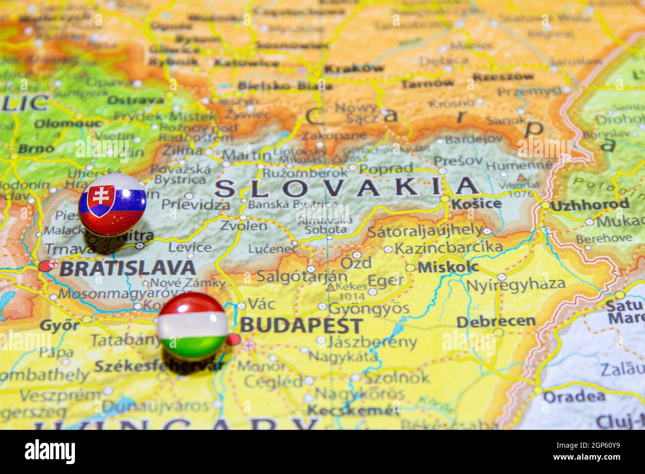 National flag Slovakia pinned on political Europe map. Macro Close up picture on a colorful and blurry world atlas. Capital country - Bratislava. Push Stock Photo