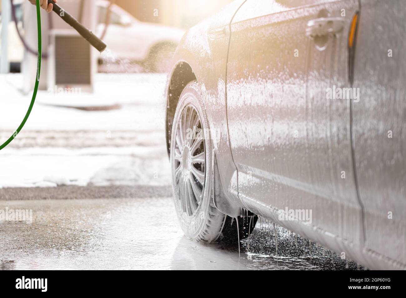 Car cleaning with high pressure in exterior carwash Stock Photo