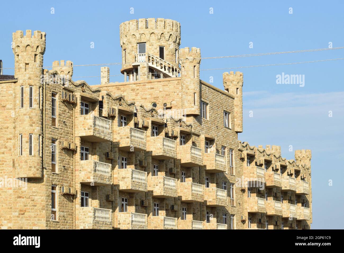 The hotel building, covered with decorative stone. Multi-storey hotel with a decorative trim, which is called Dagestani stone. Stock Photo