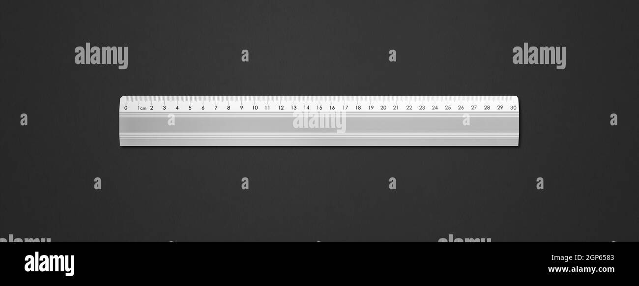 Steel metallic ruler isolated on black background Stock Photo