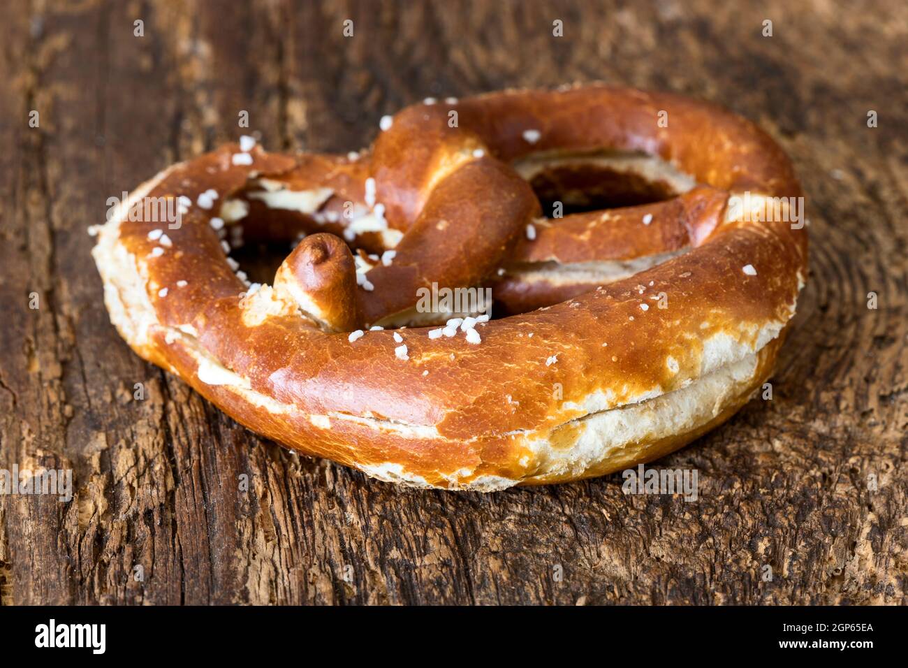 bavarian butter pretzel on dark wood Stock Photo