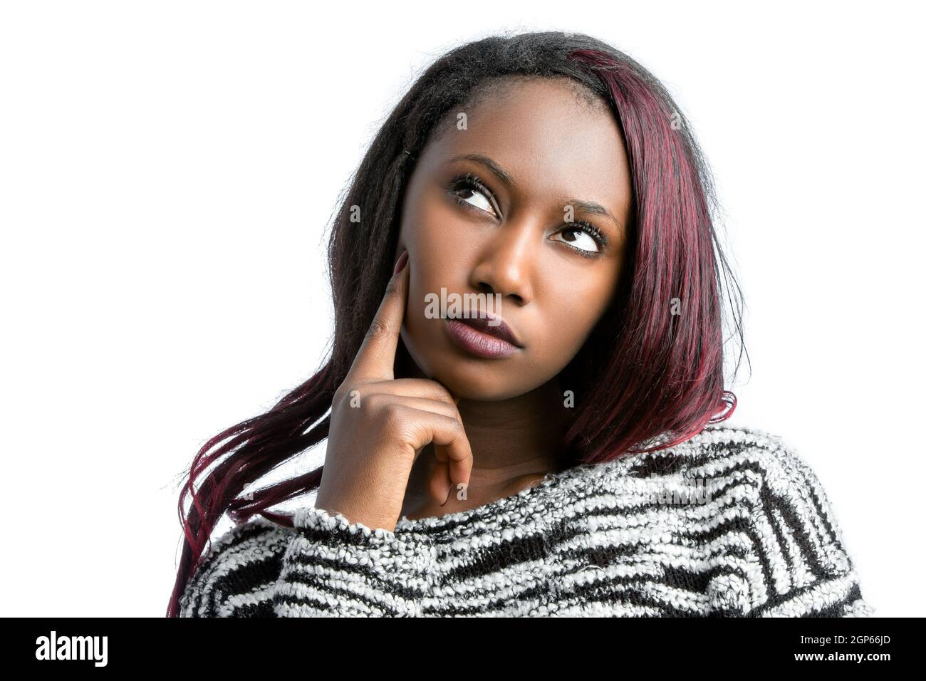 Close up portrait of attractive african teen girl looking at upper corner with wondering face expression.Isolated on white background. Stock Photo