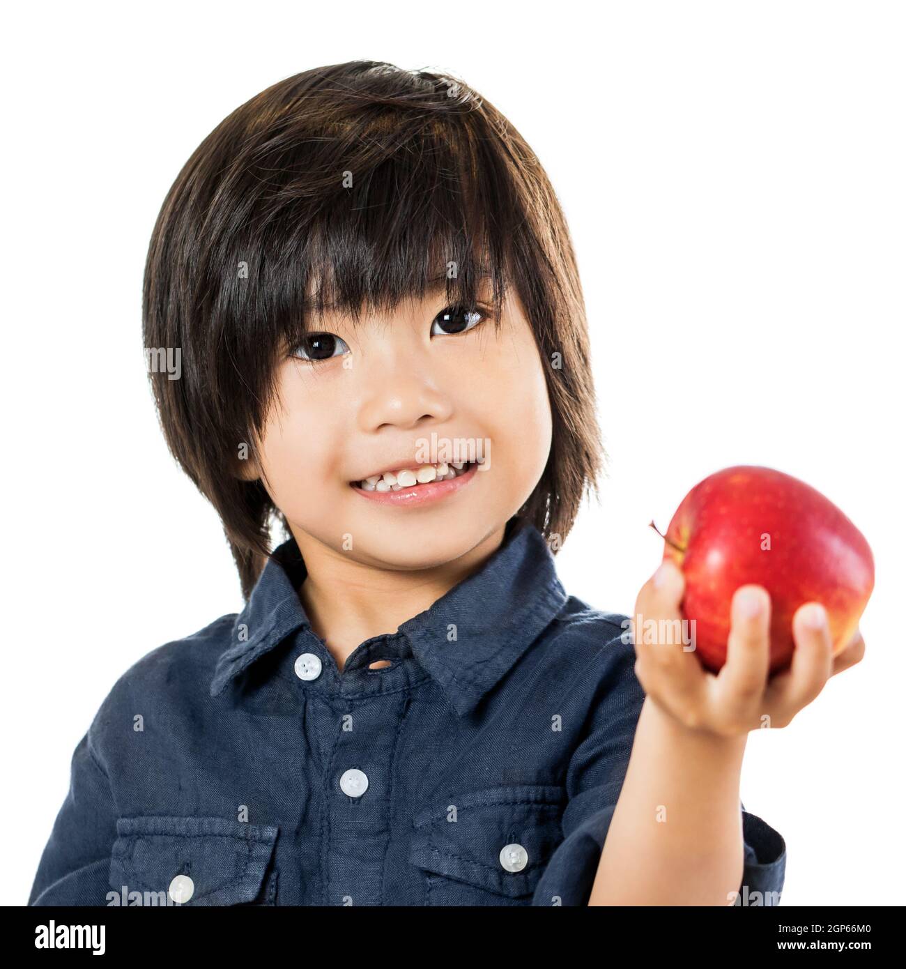 Close up cute asian child showing red apple.Isolated on white background. Stock Photo