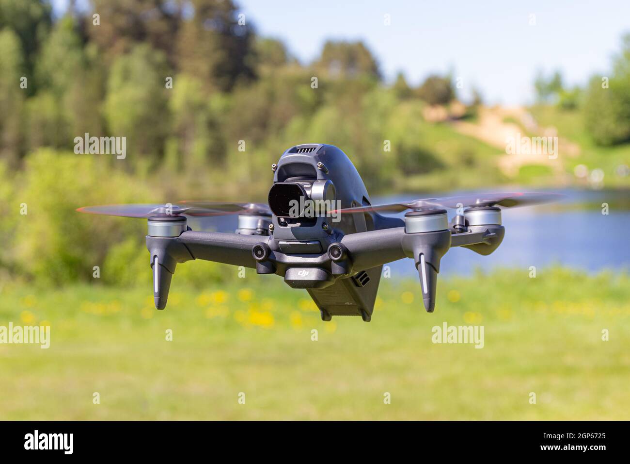 Moscow, 31 MAY 2021 : A new DJI FPV drone is flying during a sunny day on grass in beckground. Top Front View. Headless Quadcopter with Digital 4K 60 Stock Photo
