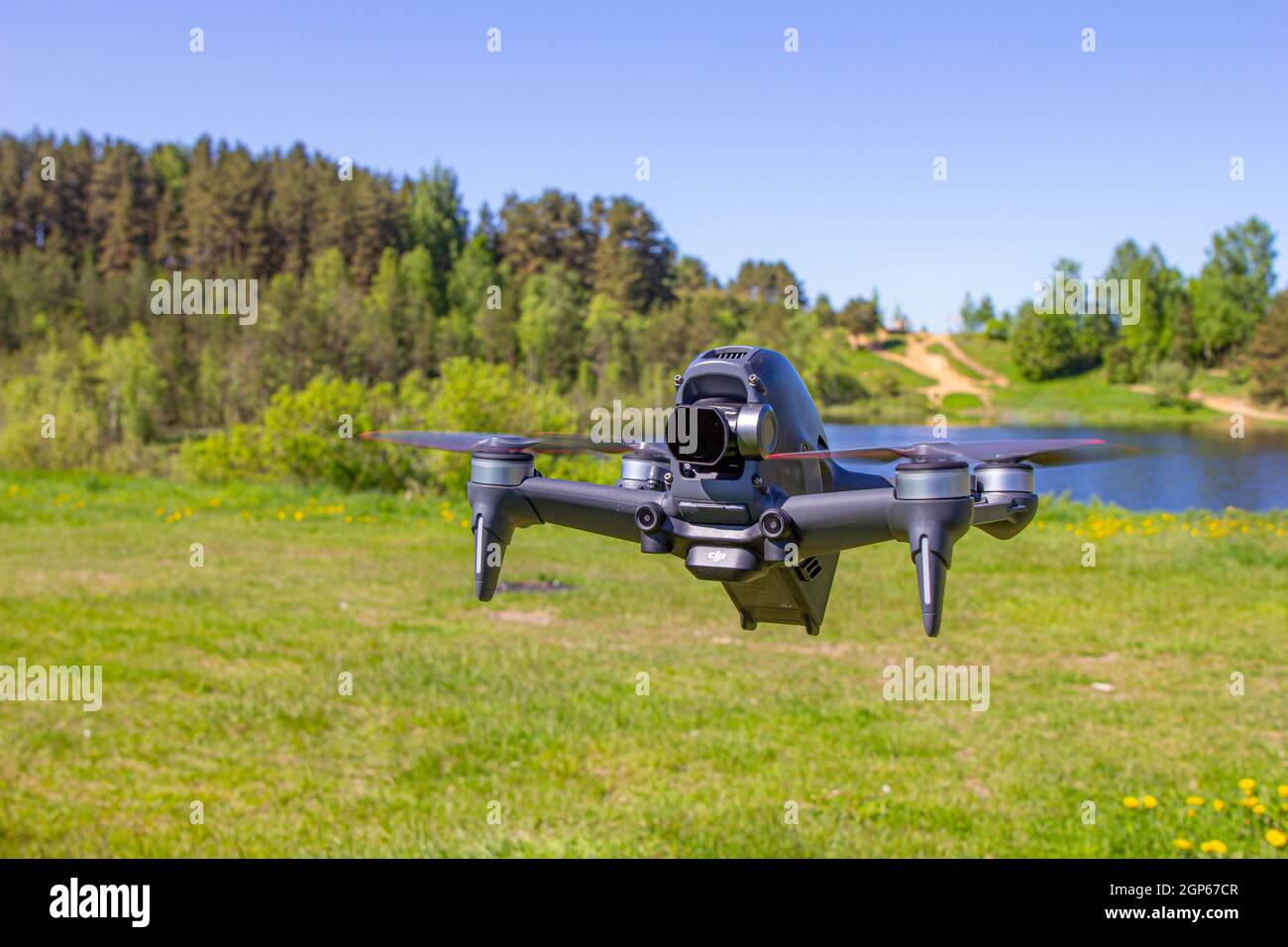 Moscow, 31 MAY 2021 : A new DJI FPV drone is flying during a sunny day on grass in beckground. Top Front View. Headless Quadcopter with Digital 4K 60 Stock Photo