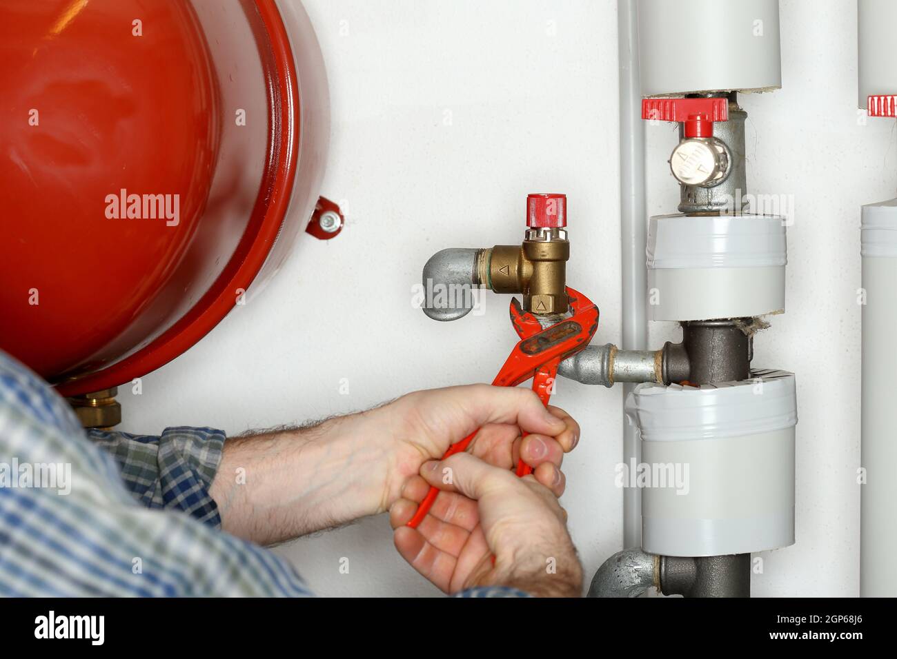 plumber is working on a heating in a house Stock Photo