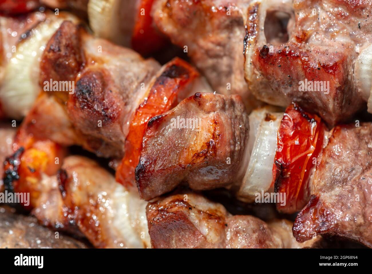 traditional barbecue meat with onions and tomatoes, close up Stock Photo