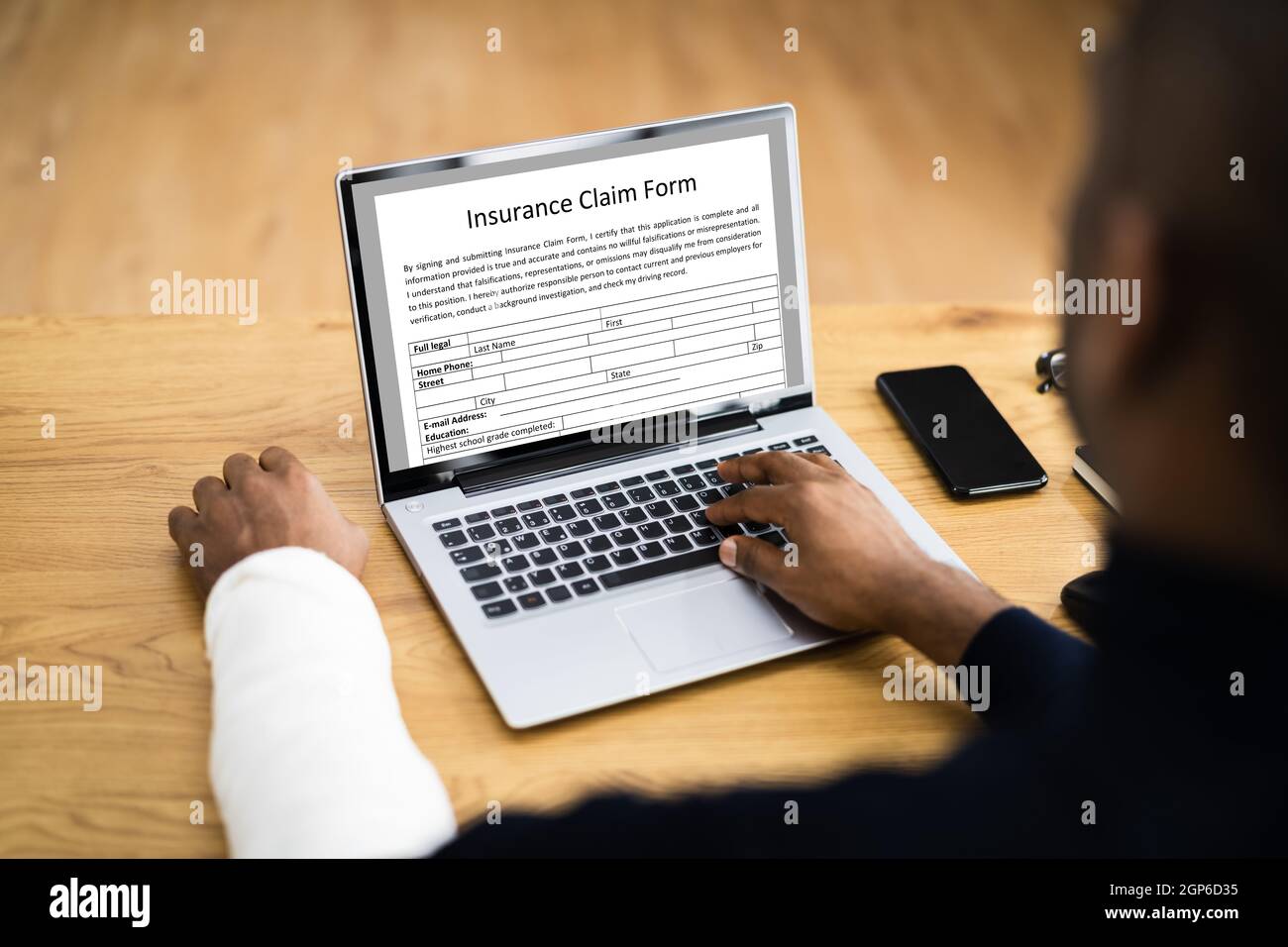 Broken Arm Injured Worker Compensation Coverage. Using Office Laptop Stock Photo