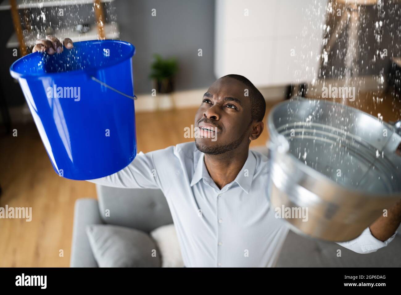 Leaking Water From Ceiling In Apartment. Holding Bucket Stock Photo Alamy
