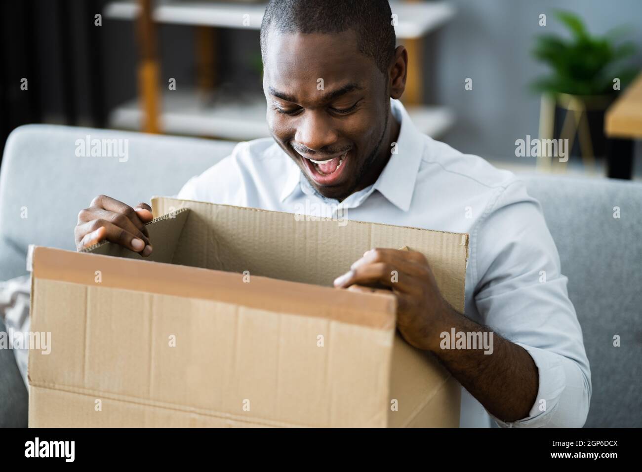 Happy African Opening Package. Receiving Parcel Gift Stock Photo Alamy
