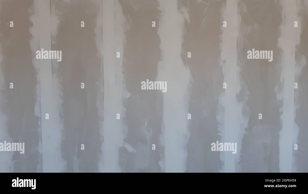 Plasterboard wall filled with plaster filler in residential room in house or apartment. Ready to