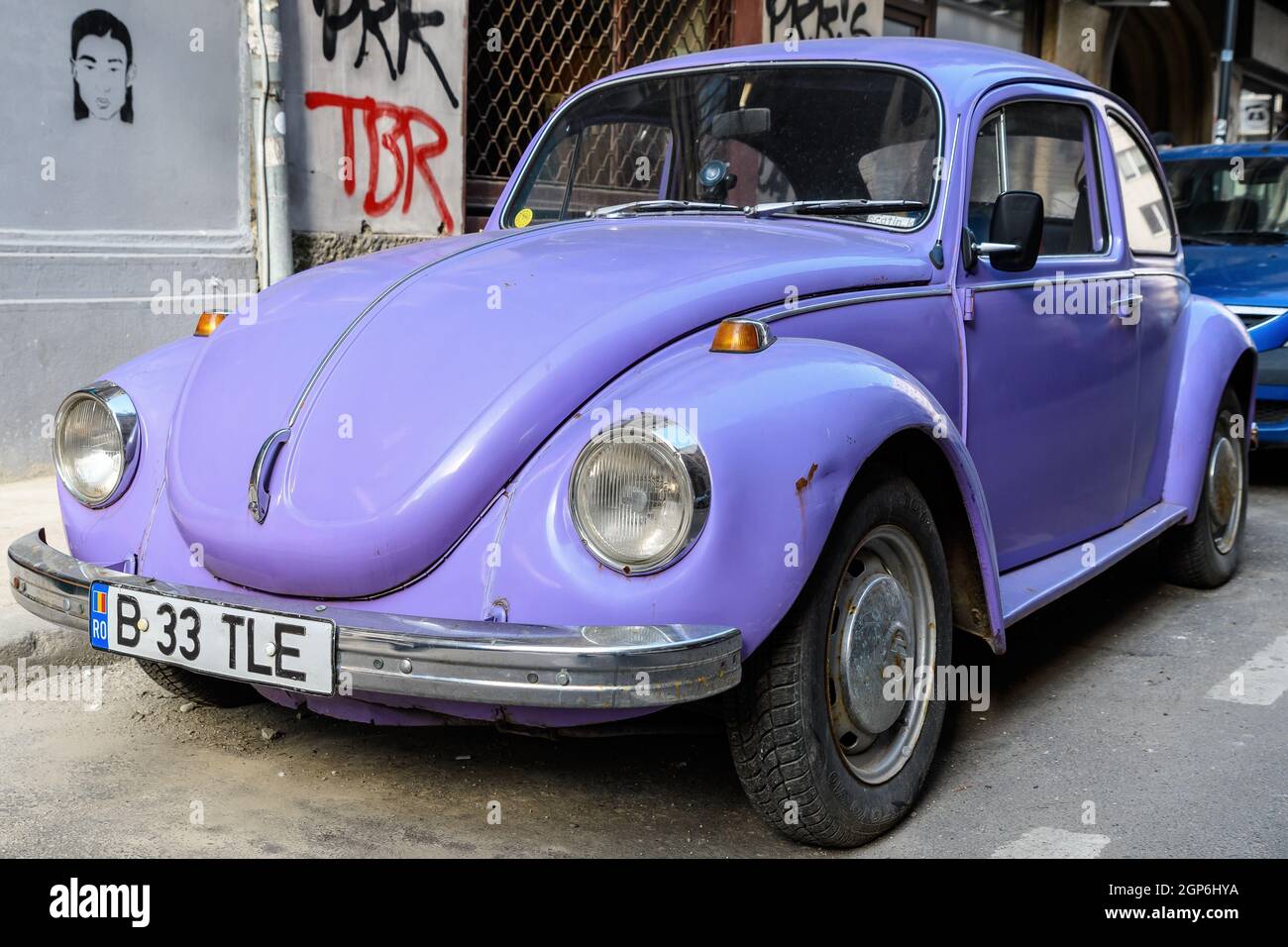 Bucharest, Romania, 9 February 2019 Old vivid mauve Volkswagen Beetle car parked a street in a sunny day Stock Photo