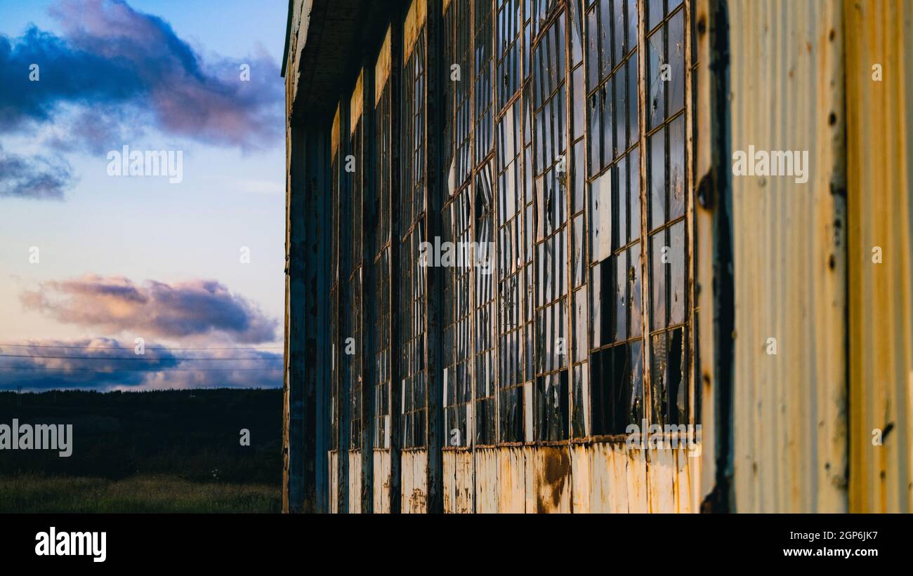 Abandoned building with broken glass windows Stock Photo - Alamy