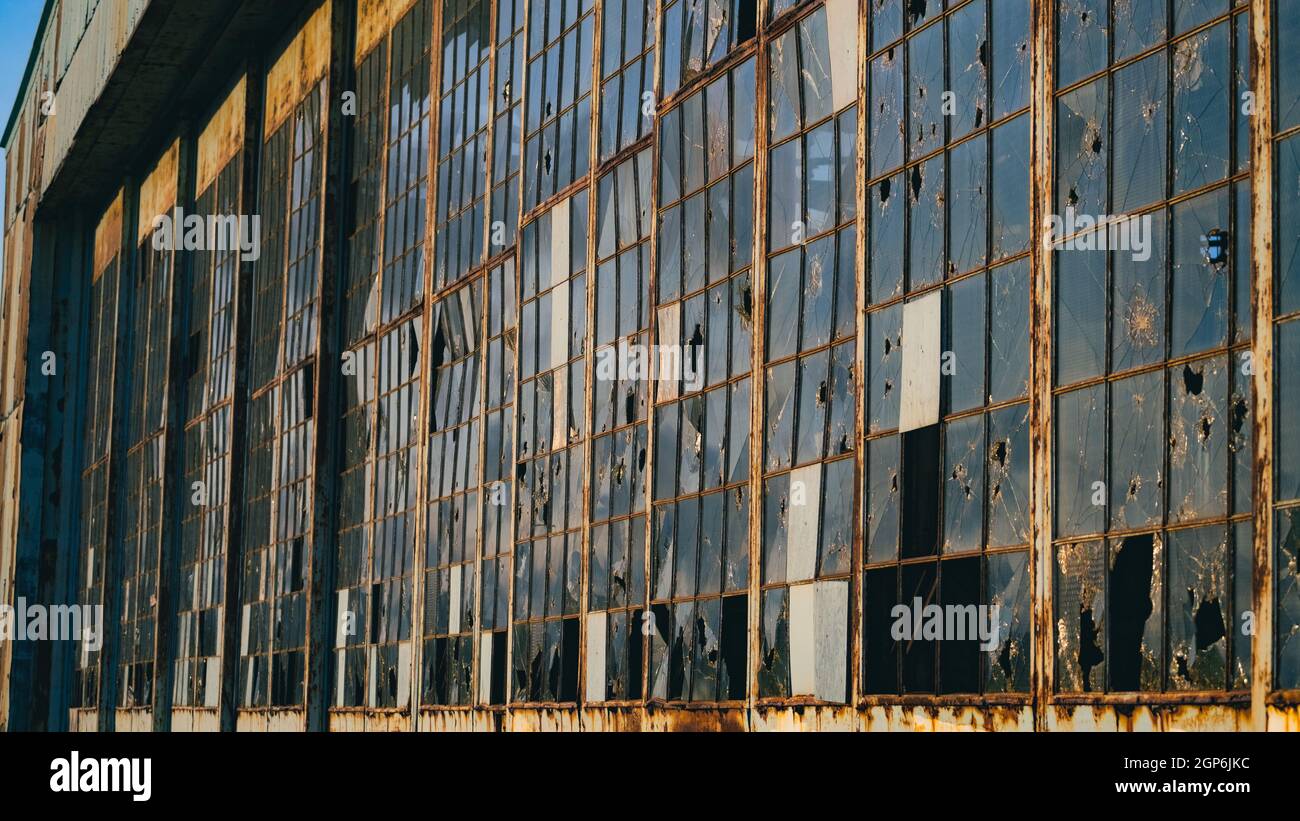 Abandoned building with broken glass windows Stock Photo - Alamy