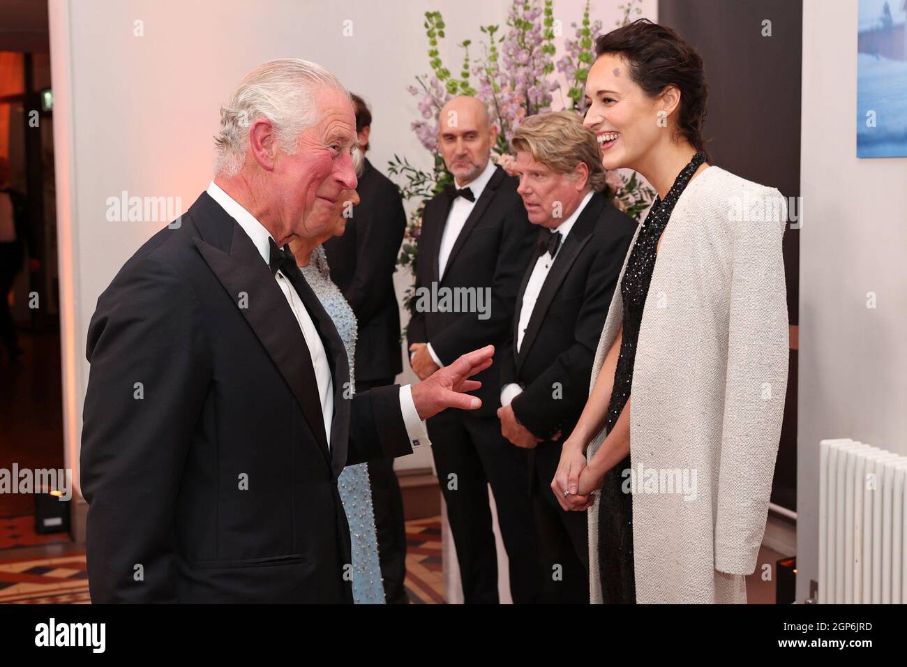 The Prince of Wales speaks with screenplay writer Phoebe Waller-Bridge upon his arrival for the World Premiere of No Time To Die, at the Royal Albert Hall in London. Picture date: Tuesday September 28, 2021. Stock Photo