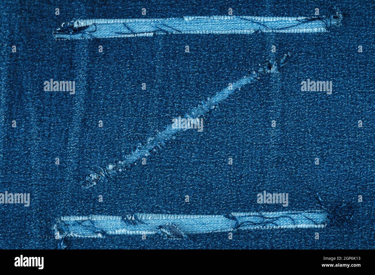 Torn jeans fabric in the shape of Z, top view Stock Photo
