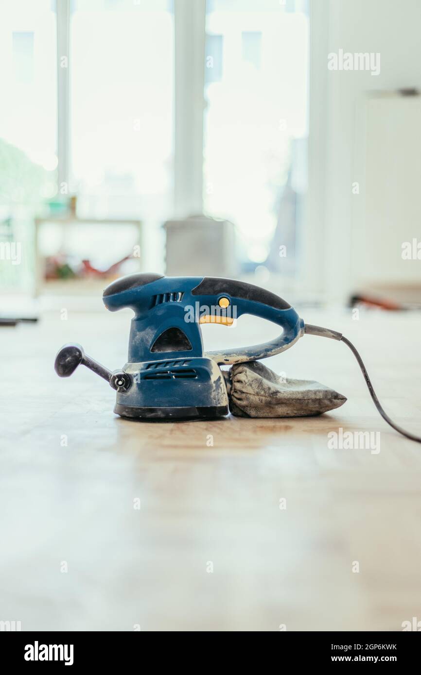 Close up of a sander power tool for DIY on wooden parquet floor Stock Photo