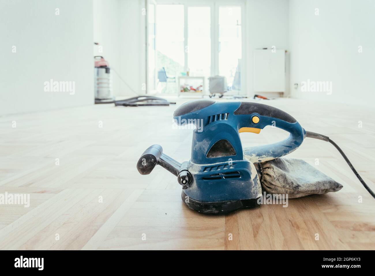 Close up of a sander power tool for DIY on wooden parquet floor Stock Photo