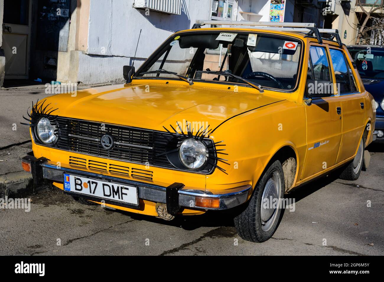 Bucharest, Romania, 1 January 2021 Old yellow Skoda car from Checz Republic, decorated on a street in a sunny winter day Stock Photo