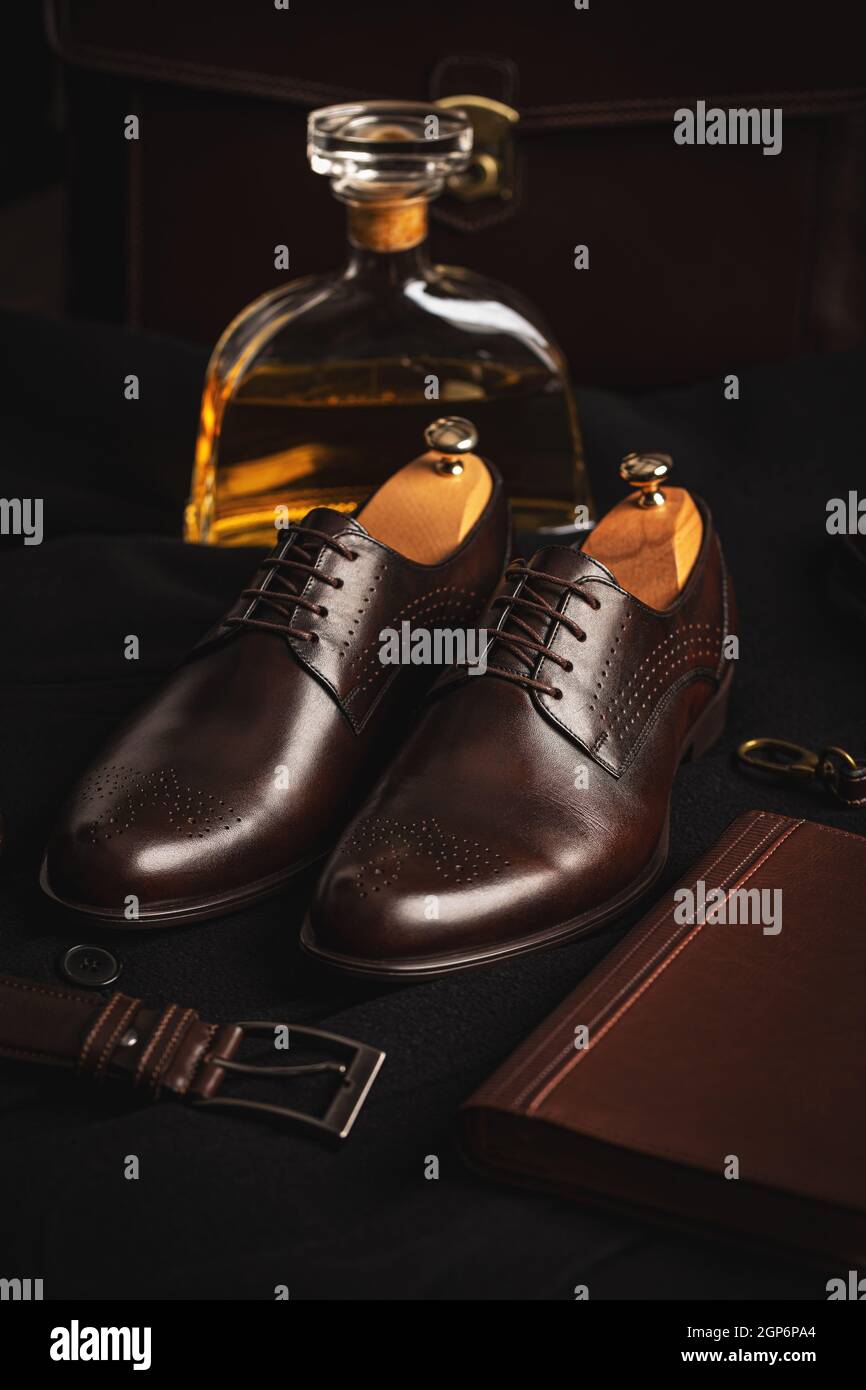 Stylish men's shoes, belt and diary on a black background Stock Photo