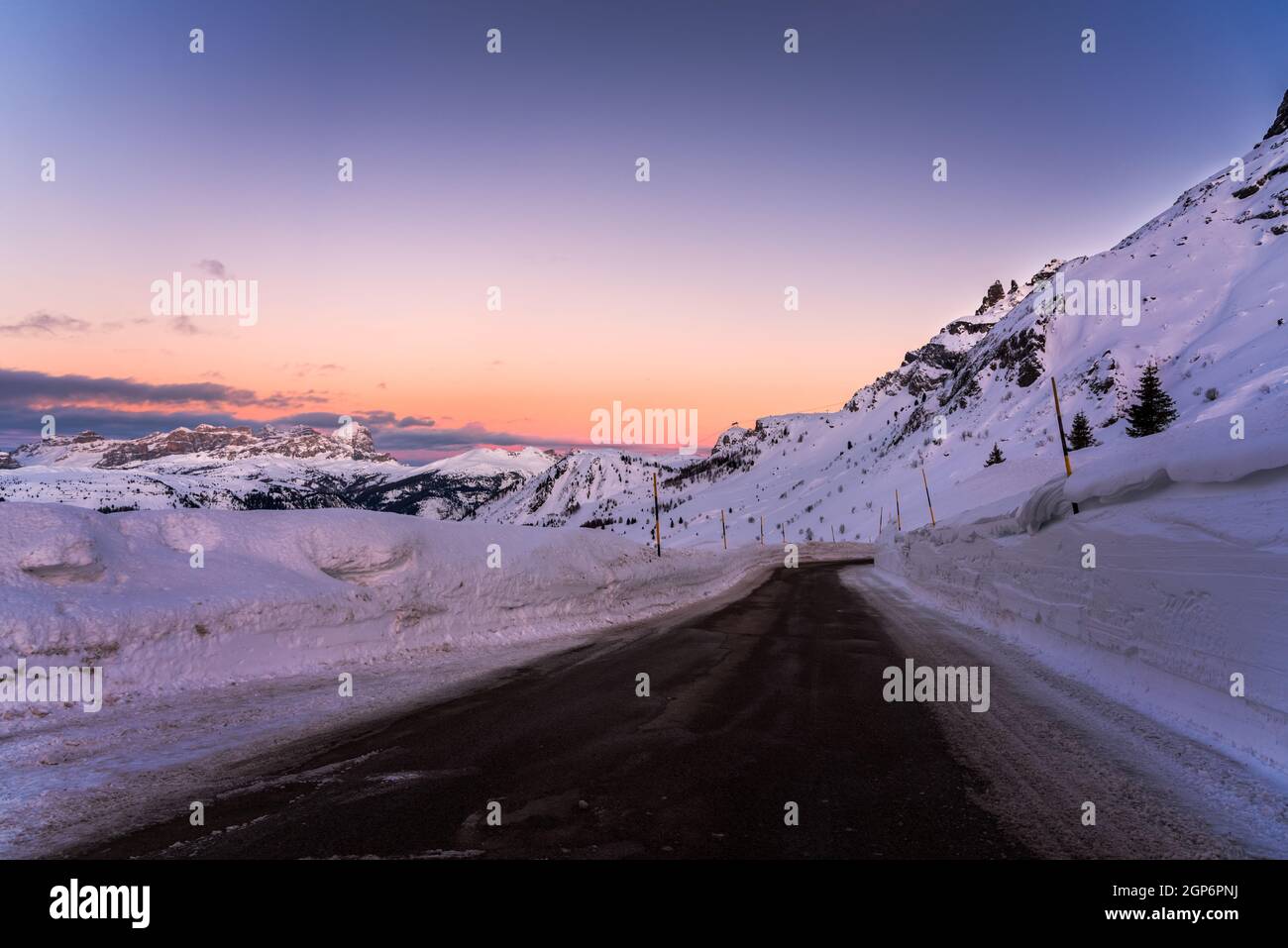 High altitude alpine road cleared of snow at dusk in winter Stock Photo