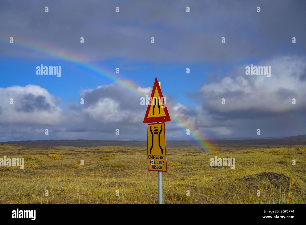 Rainbow over the autumn coloured landscape and road sign one lane bridge, road 864, Norourland eystra, Iceland Stock Photo
