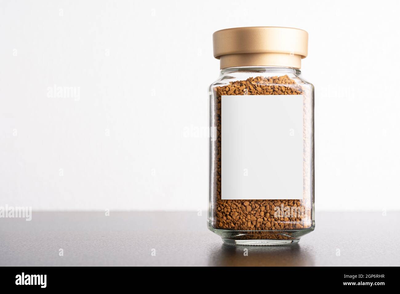 Instant coffee in a glass jar with blank label isolated on white background, editable mockup