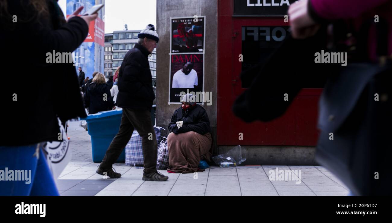 MALMO, SWEDEN Sep 01, 2021 A homeless woman sitting on the ground in