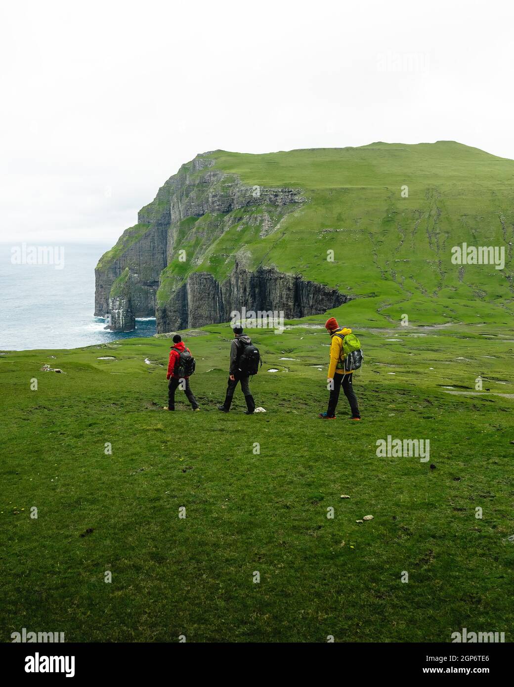 3 Hikers go to Asmundarstakkur cliff, Sandvik, Suduroy, Faroe Islands Stock  Photo - Alamy