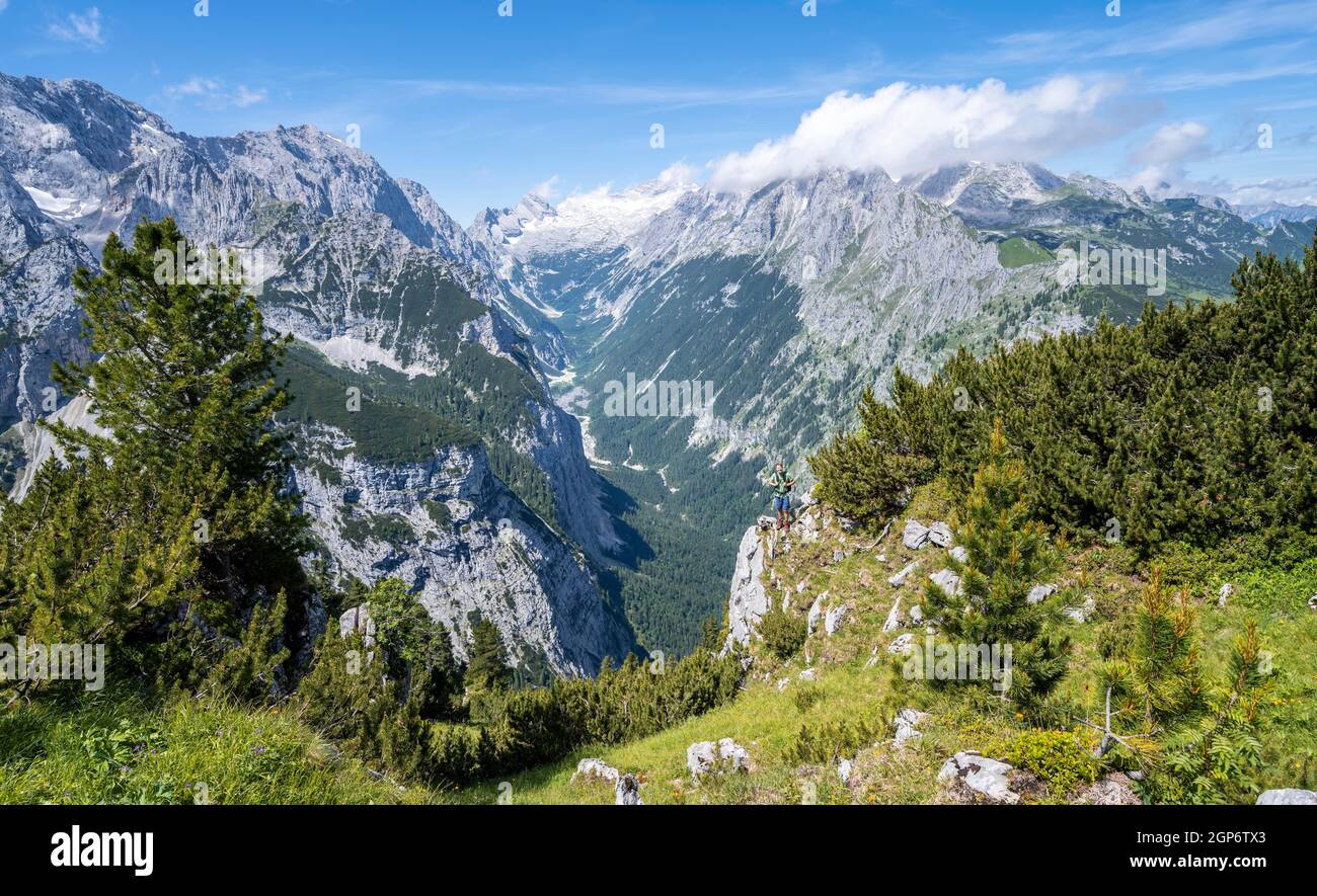 Hiker looking into the distance, view into the Reintal valley, in the background summit of the Zugspitze and Alpspitze with Zugspitzplatt, hiking Stock Photo