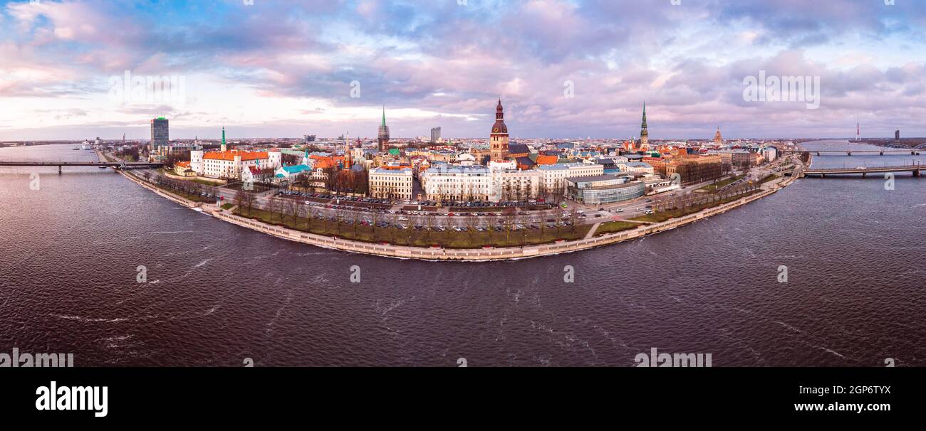 Beautiful aerial panoramic view from old town at sunset near river Daugava, TV tower, embankment and bridge. Riga cityscape in clouds autumn day. Famo Stock Photo