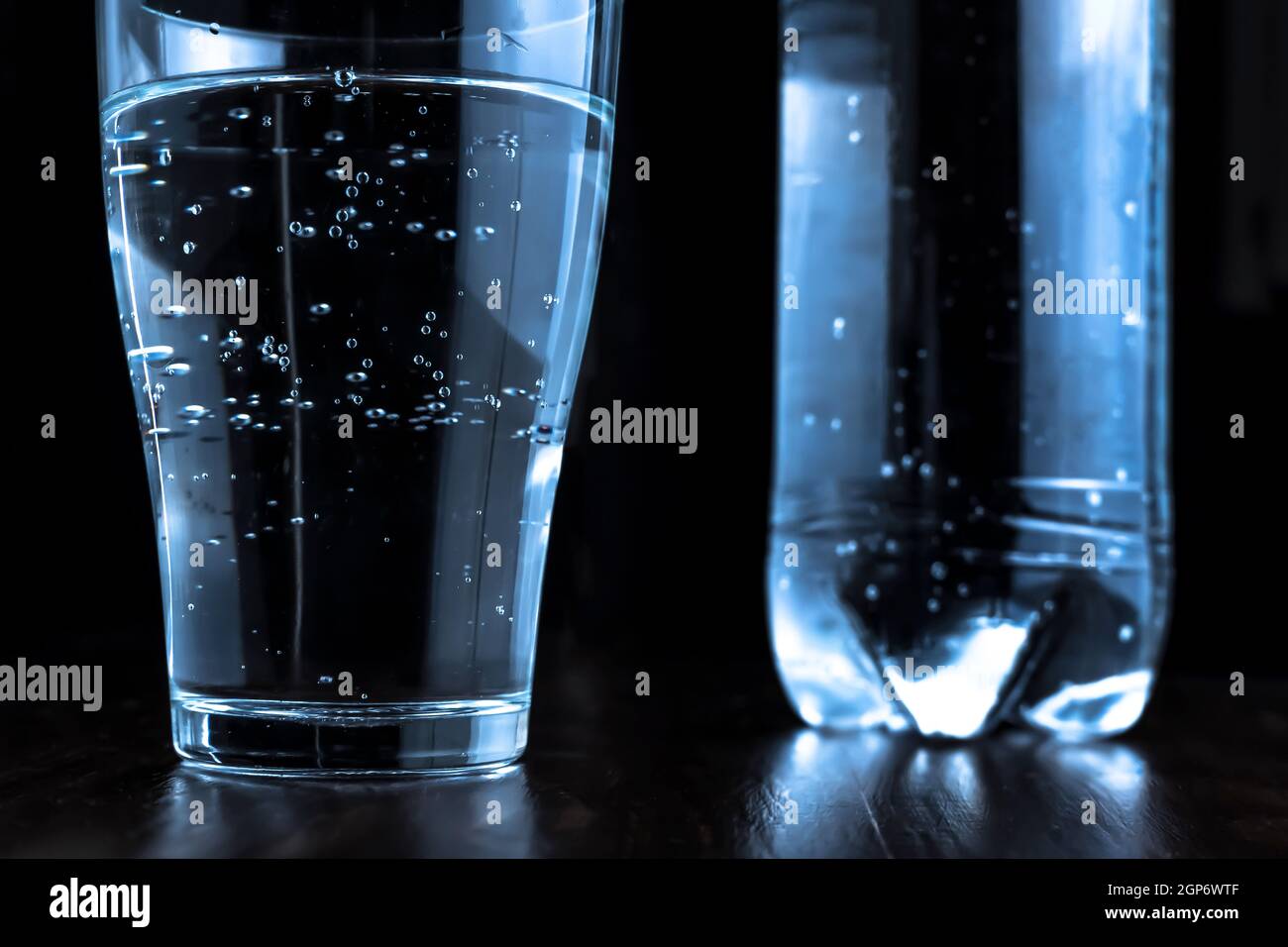 A glass of sparkling water or soda. Sparkling mineral water in a glass