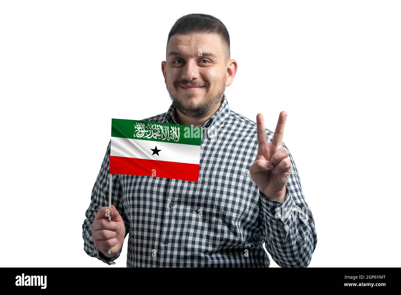 White guy holding a flag of Somaliland and shows two fingers isolated on a white background. Stock Photo
