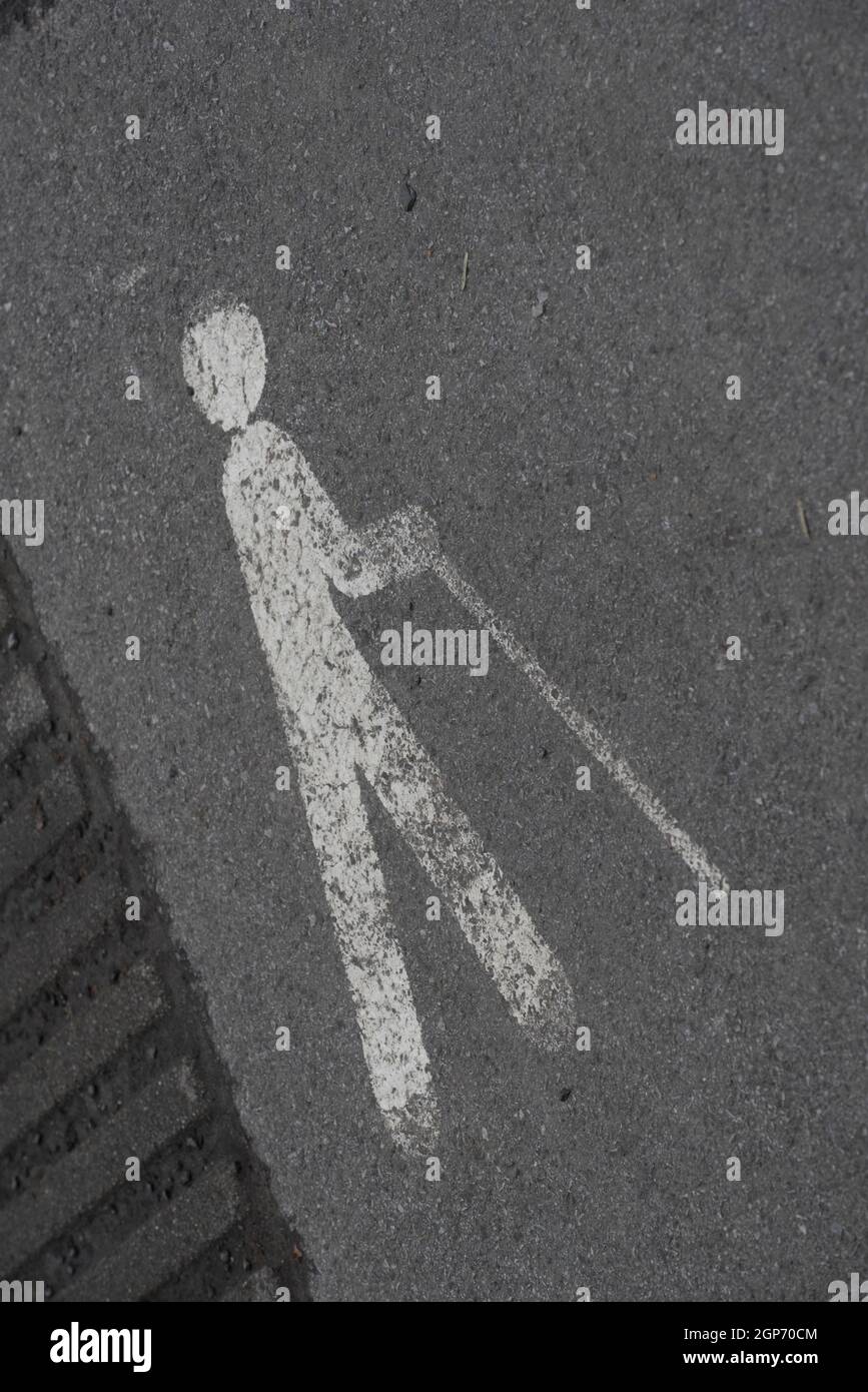 a walking aid and accessibility sign, marking on the street Stock Photo