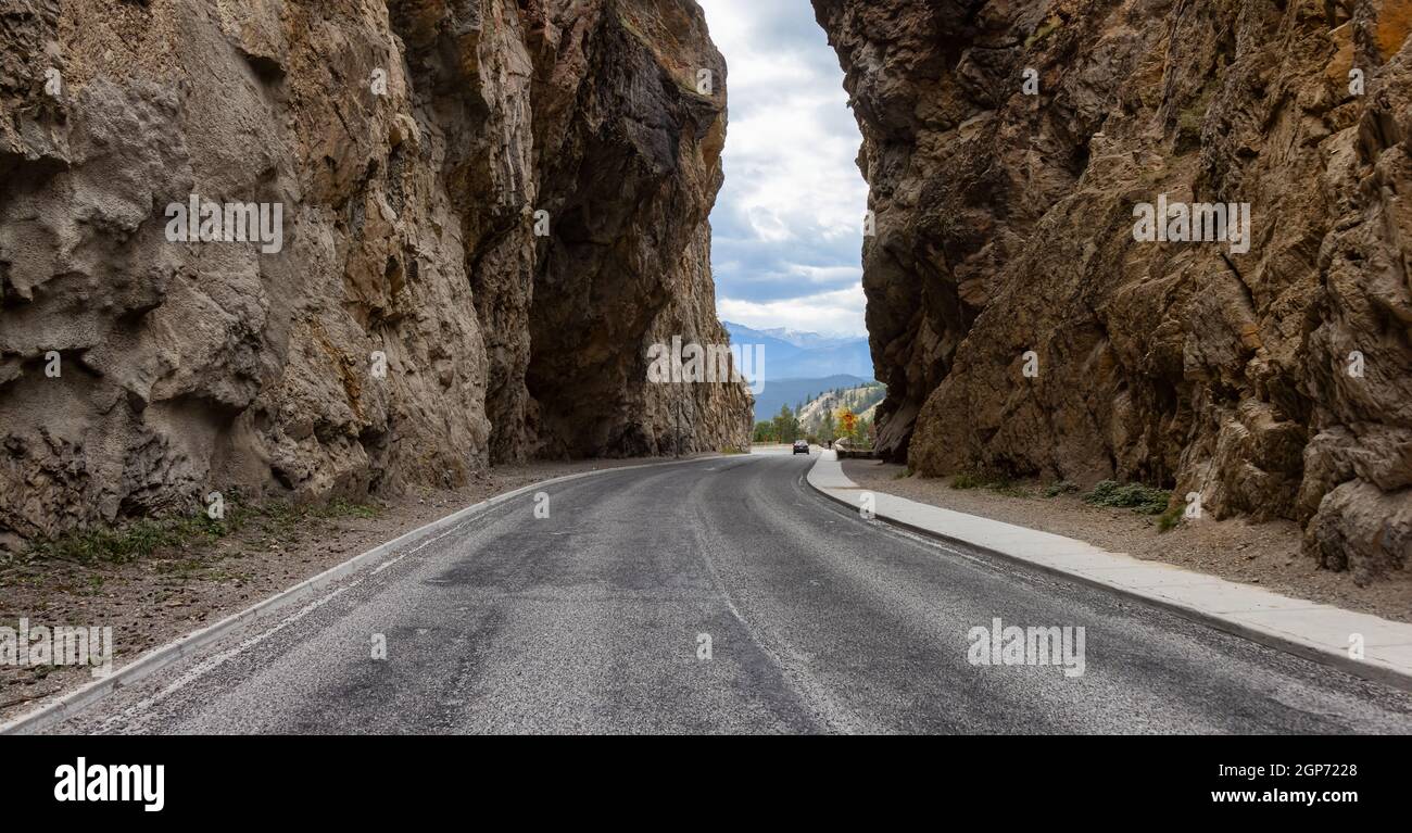 Scenic Road in the rocky canyon cliffs by Canadian Mountains. Stock Photo
