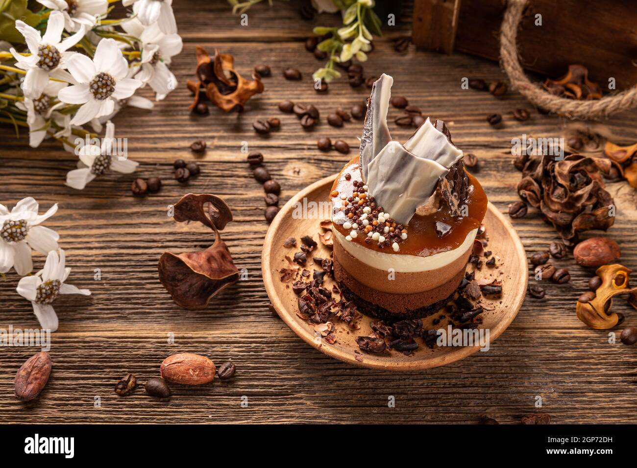 Four layered choclate and coffee mousee mini round cake with salty caramel topping Stock Photo