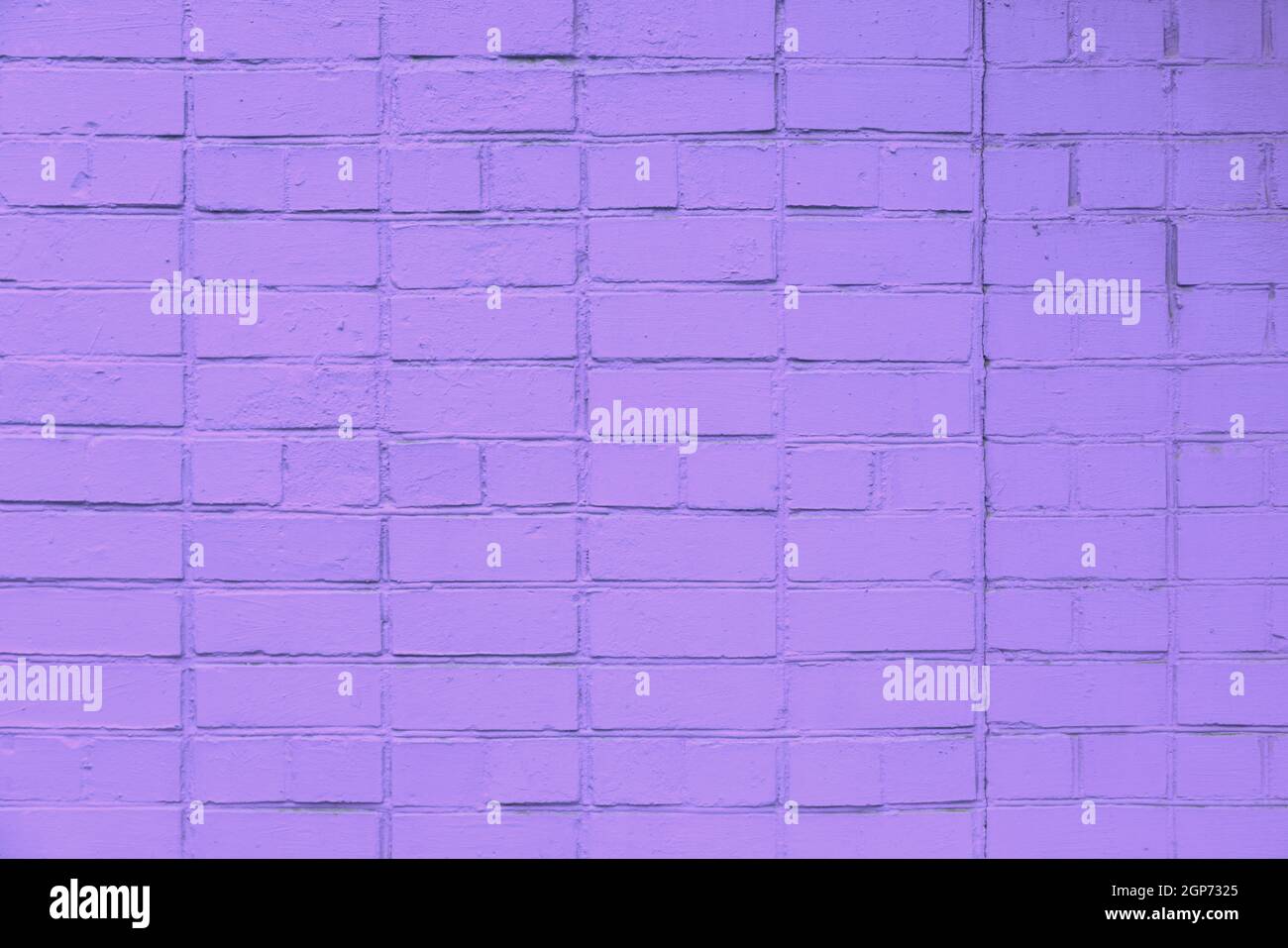 matte violet painted brick wall full frame flat background and texture Stock Photo
