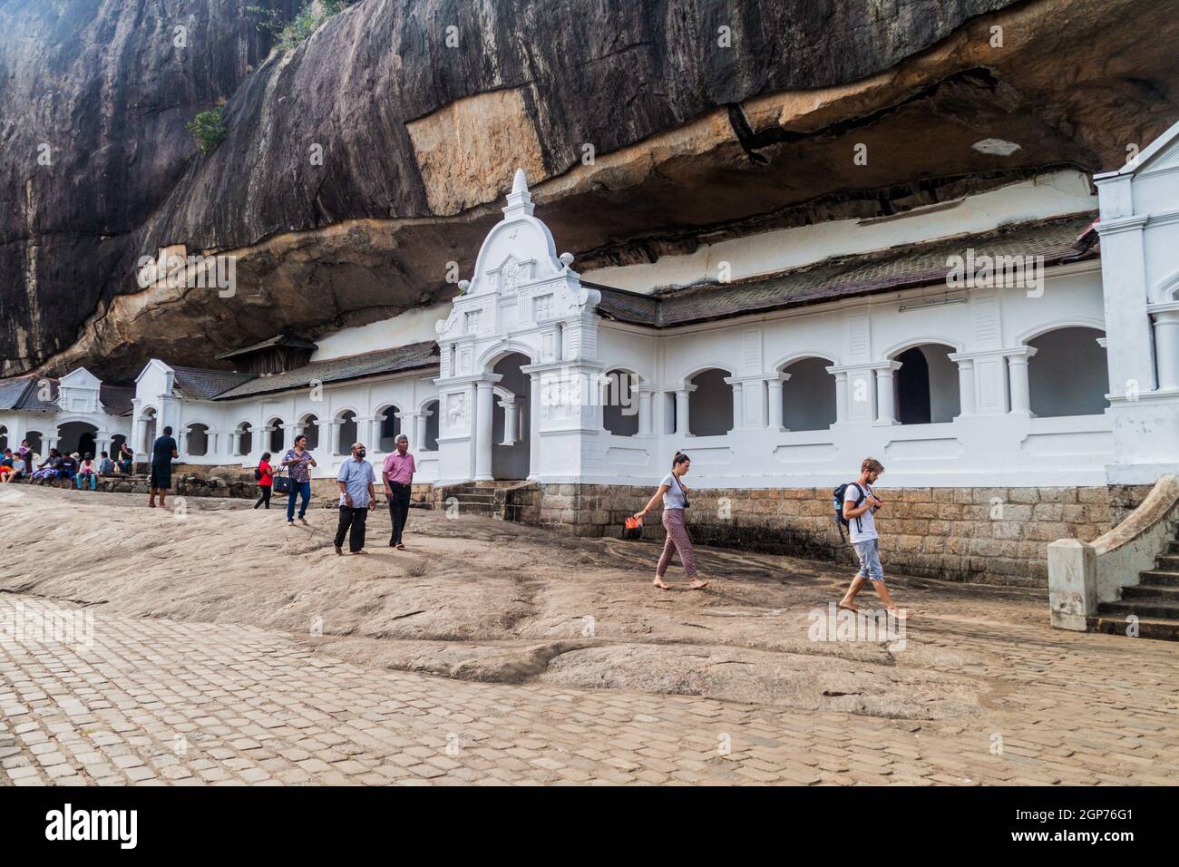 DAMBULLA, SRI LANKA - JULY 20, 2016: Tourists and devotees visit Dambulla cave temple, Sri Lanka Stock Photo