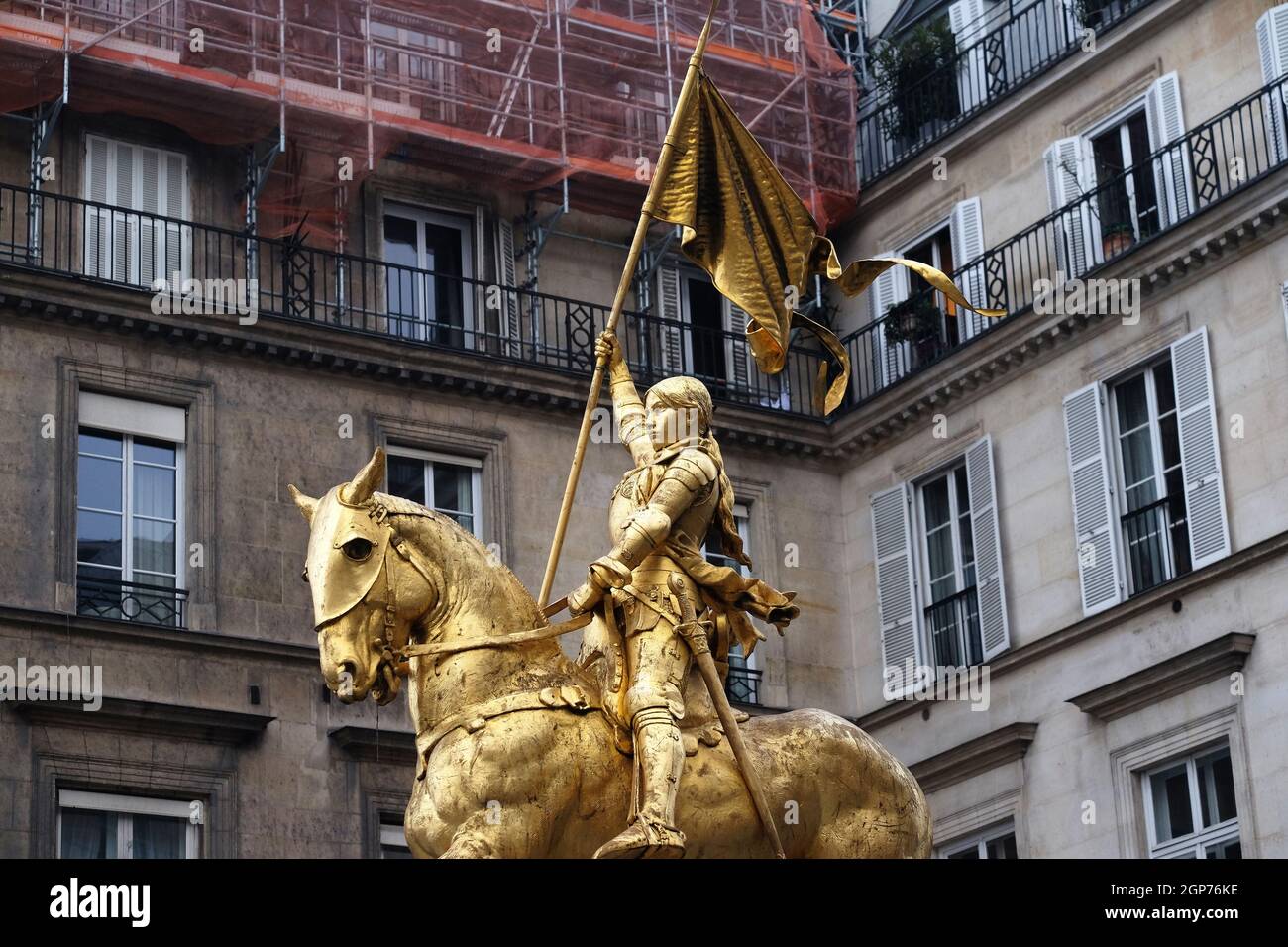 Golden statue of Joan of Arc on horseback in Paris near Louvre Museum