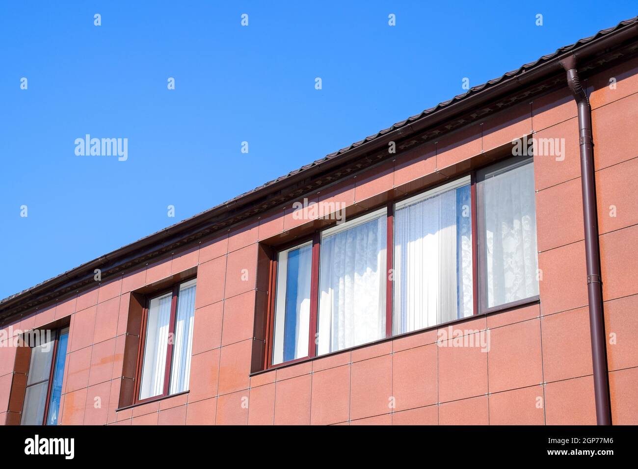 Plastic windows on the house and a spillway system on the roof. House
