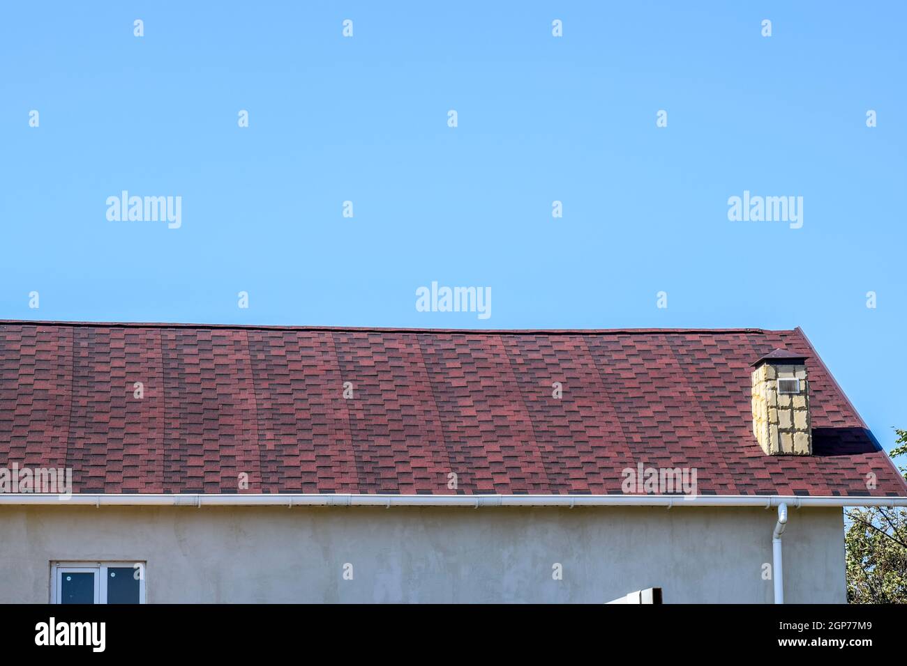 Bituminous burgundy roof. Roof from multi-colored bituminous shingles